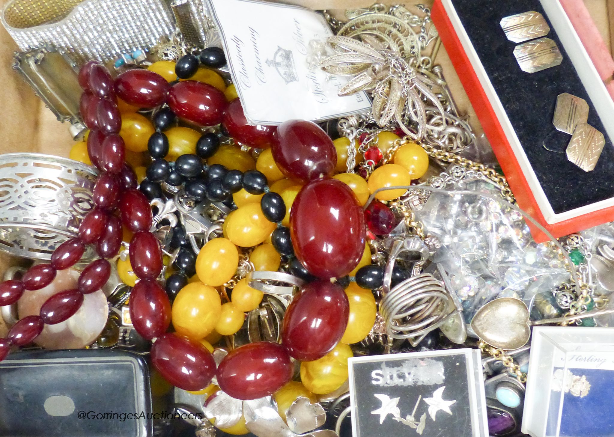 Mixed jewellery and silver etc. including a simulated cherry amber necklace, gross 81 grams, silver and 925 bracelets, rings charms, chains and a silver napkin ring.